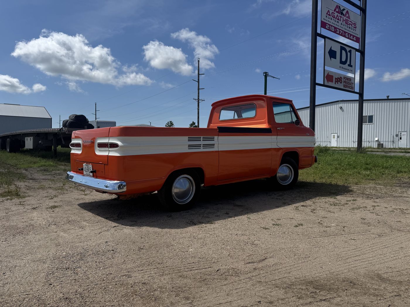 Orange and white pickup, rear