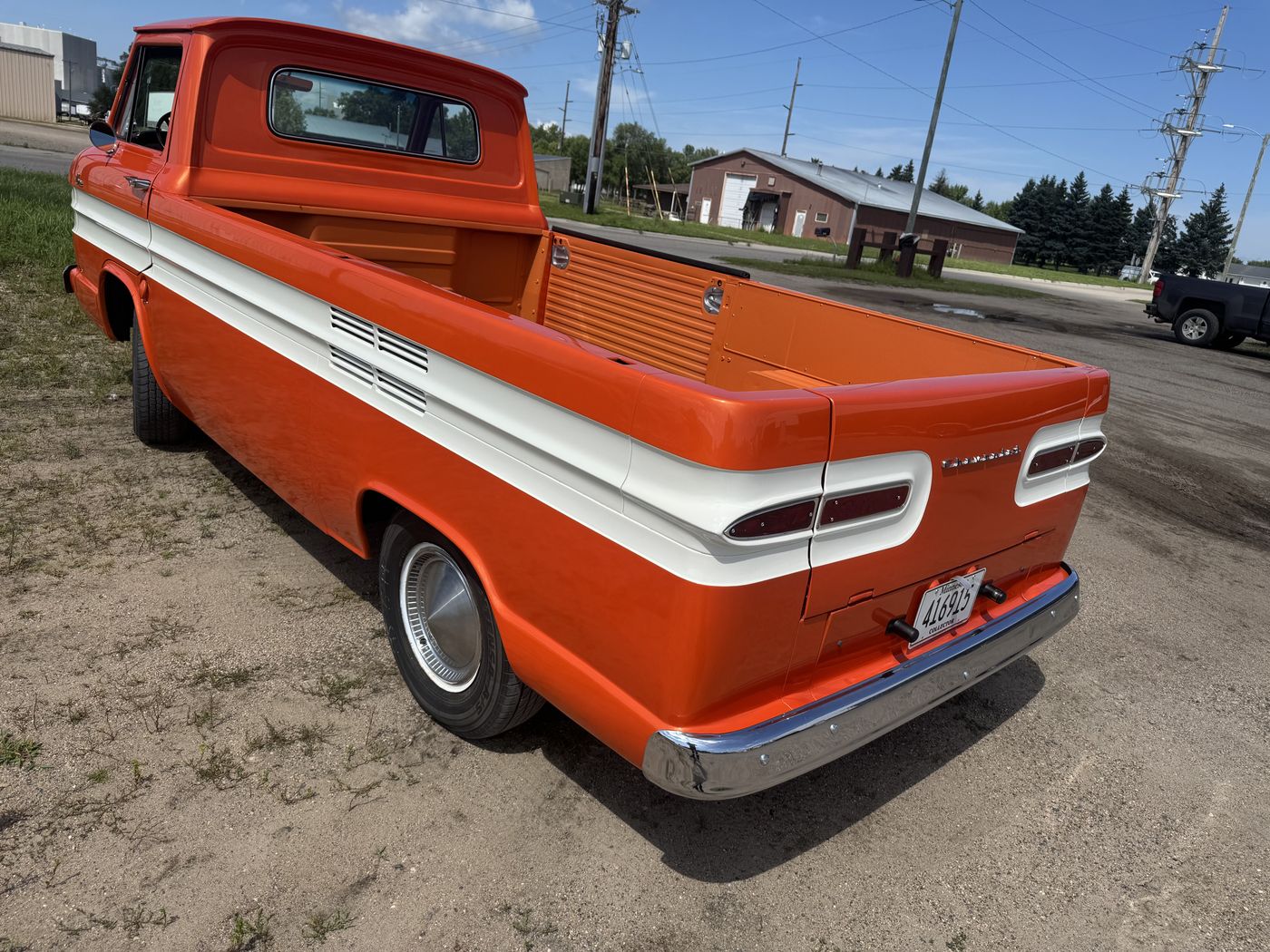 Orange and white pickup, bed and tail