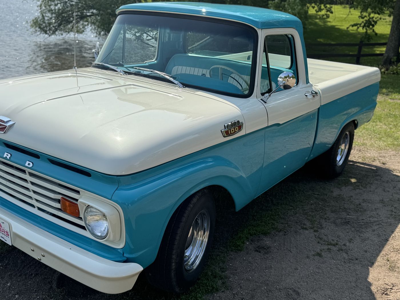 Turquoise and white pickup, front three-quarter
