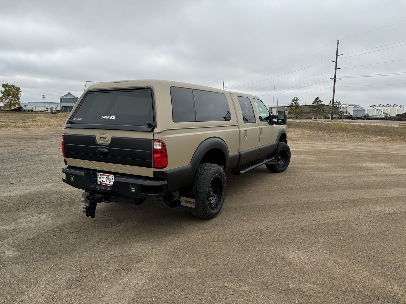 Tan crew cab, rear three-quarter