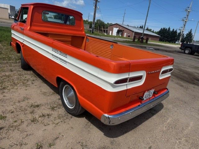 Orange and white pickup, rear