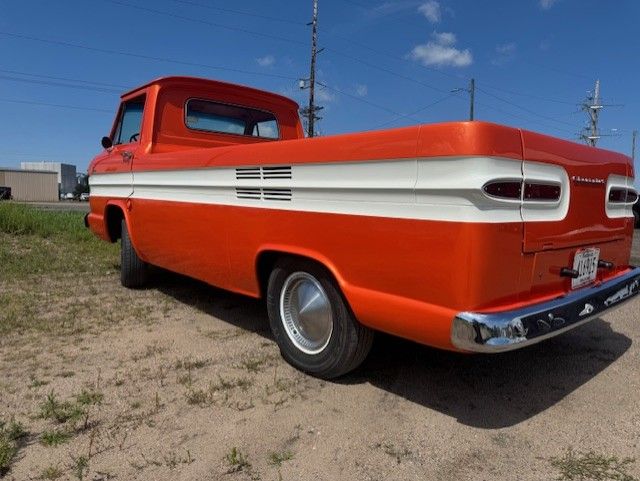 Orange and white pickup, side